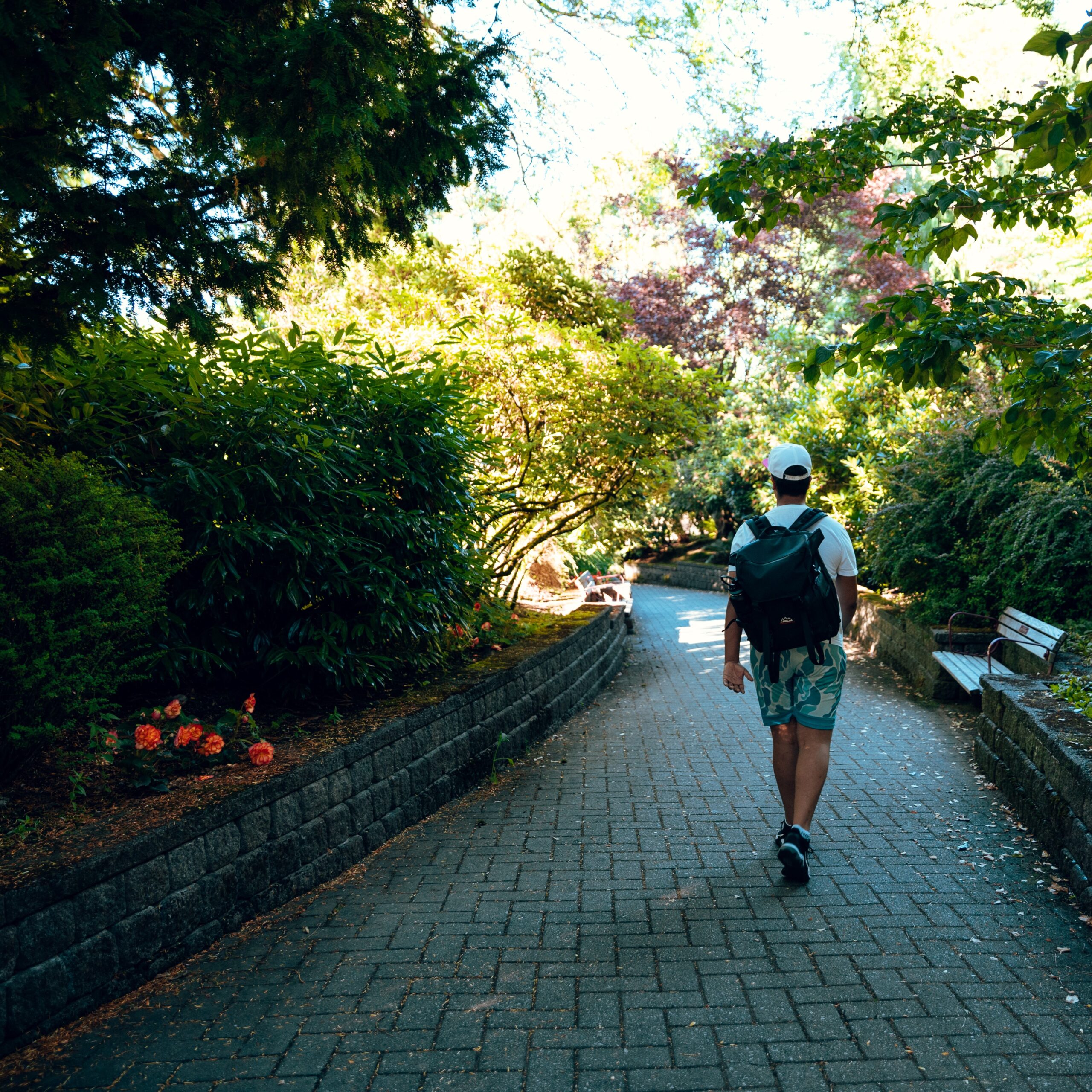 Man walking down a path in a park.